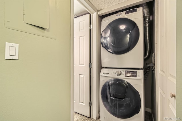 laundry area with stacked washer / drying machine