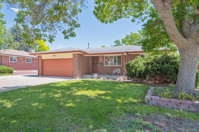 1774 S Dover Way, Lakewood, CO 80232 - single story home with an attached garage, concrete driveway, brick siding, and a front lawn