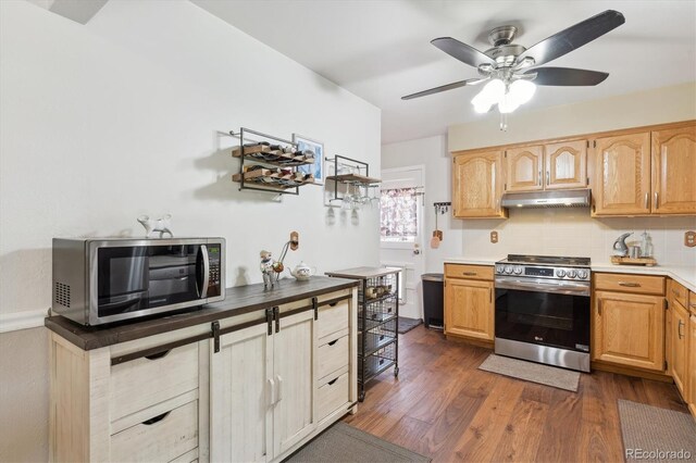 1774 S Dover Way, Lakewood, CO 80232 - kitchen featuring stainless steel appliances, under cabinet range hood, a ceiling fan, dark wood finished floors, and light brown cabinetry
