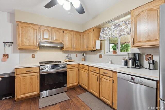 1774 S Dover Way, Lakewood, CO 80232 - kitchen featuring stainless steel appliances, under cabinet range hood, ceiling fan, and backsplash
