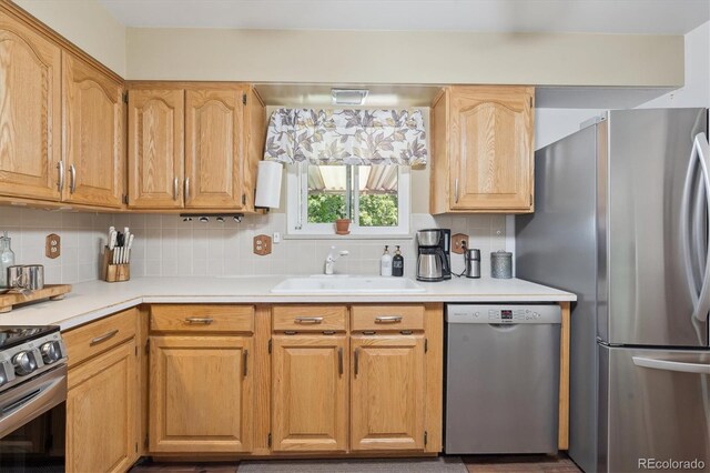 1774 S Dover Way, Lakewood, CO 80232 - kitchen featuring stainless steel appliances, tasteful backsplash, and light countertops