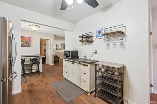 1774 S Dover Way, Lakewood, CO 80232 - home office with ceiling fan and dark wood-style flooring