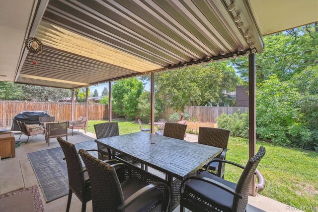 1774 S Dover Way, Lakewood, CO 80232 - fenced backyard with a patio area, outdoor dining area, and an outdoor hangout area