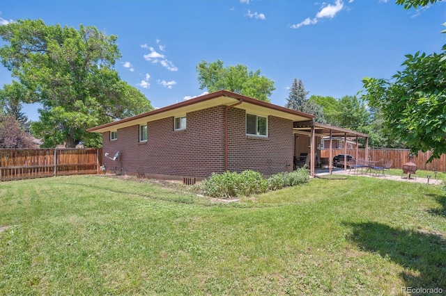 1774 S Dover Way, Lakewood, CO 80232 - back of house with a patio, a fenced backyard, and brick siding