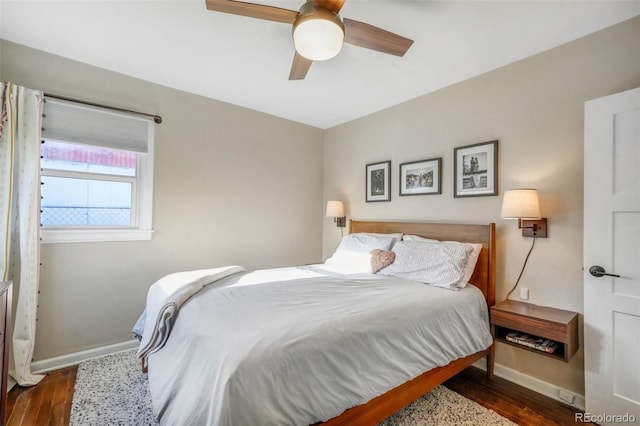 bedroom featuring wood finished floors, a ceiling fan, and baseboards