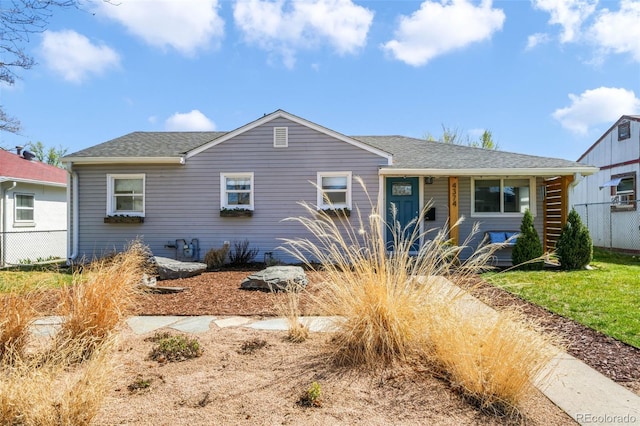 view of front of house featuring fence and a shingled roof