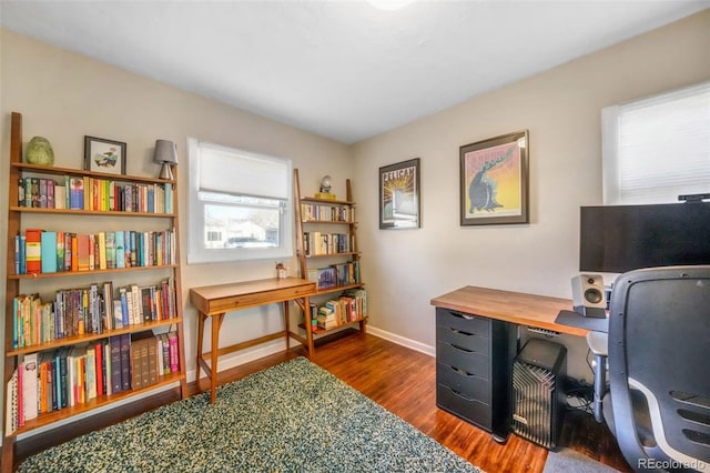 office featuring dark wood-type flooring, a wealth of natural light, and baseboards