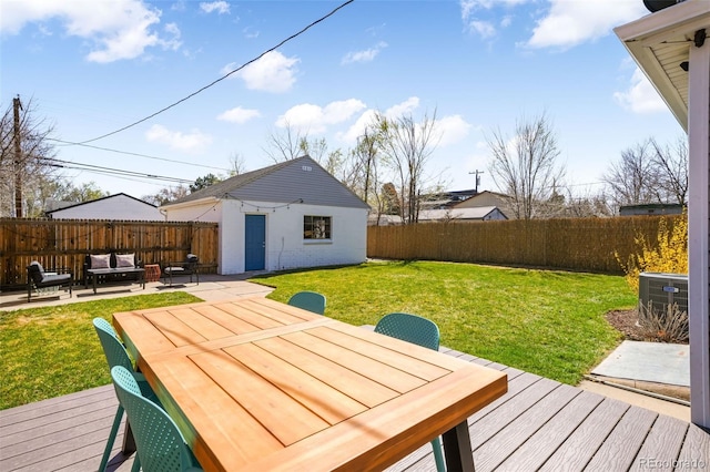 wooden terrace featuring a lawn, a fenced backyard, an outdoor structure, outdoor dining area, and central air condition unit