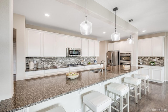 10387 Harrisburg St, Parker, CO 80134 - kitchen featuring appliances with stainless steel finishes, decorative backsplash, white cabinetry, and recessed lighting