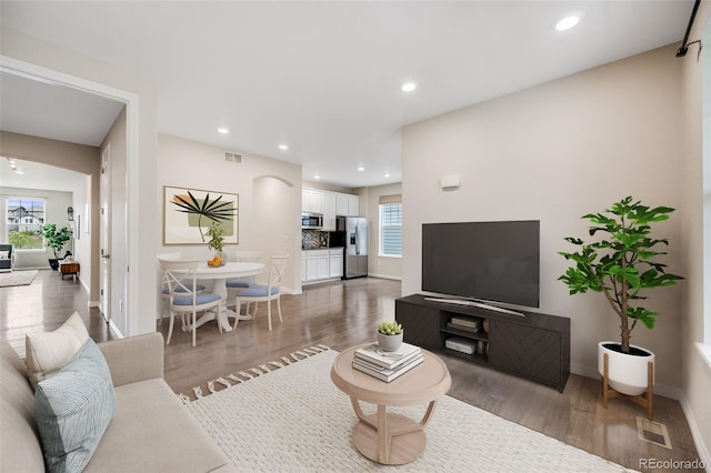 10387 Harrisburg St, Parker, CO 80134 - living area featuring wood finished floors and recessed lighting