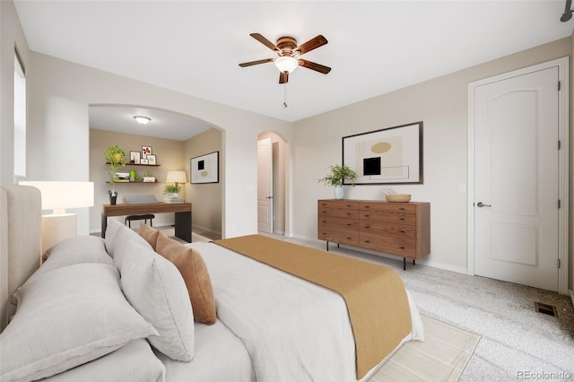 10387 Harrisburg St, Parker, CO 80134 - bedroom with arched walkways, carpet floors, and a ceiling fan