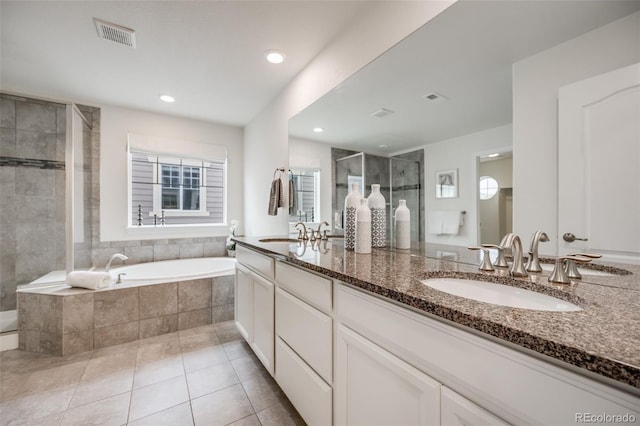 10387 Harrisburg St, Parker, CO 80134 - full bathroom with double vanity, a stall shower, a bath, tile patterned floors, and recessed lighting