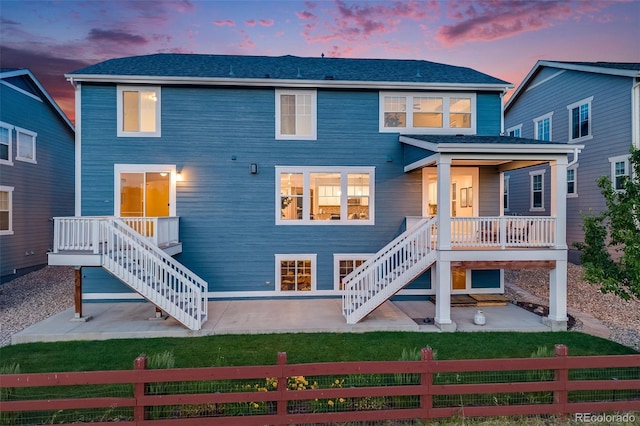 10387 Harrisburg St, Parker, CO 80134 - back of house at dusk with stairway and a patio area