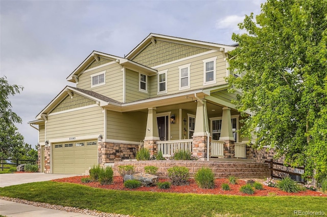 23503 E Minnow Dr, Aurora, CO 80016 - craftsman-style house featuring a porch, stone siding, a garage, and driveway