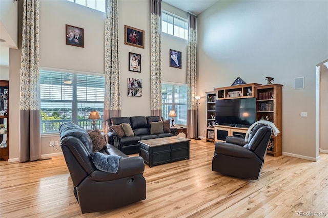 23503 E Minnow Dr, Aurora, CO 80016 - living room featuring a high ceiling, wood finished floors, and healthy amount of natural light