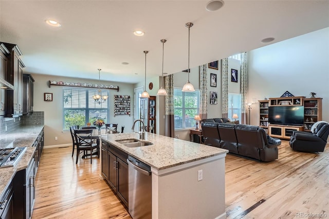 23503 E Minnow Dr, Aurora, CO 80016 - kitchen featuring stainless steel appliances, light wood-type flooring, healthy amount of natural light, light stone countertops, and recessed lighting