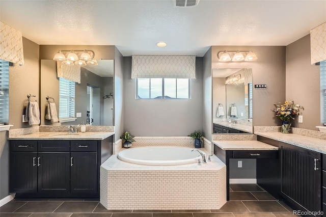 23503 E Minnow Dr, Aurora, CO 80016 - bathroom with plenty of natural light, tile patterned flooring, a garden tub, and two vanities