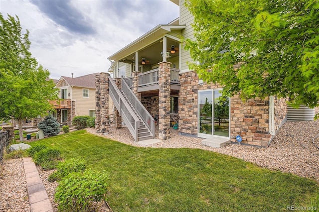 23503 E Minnow Dr, Aurora, CO 80016 - rear view of property with ceiling fan, a lawn, stone siding, and stairs