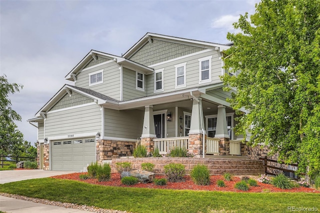 23503 E Minnow Dr, Aurora, CO 80016 - craftsman-style house featuring covered porch, a garage, driveway, and stone siding