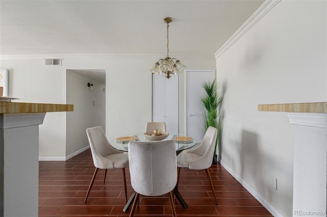 dining space with crown molding, a chandelier, and dark hardwood / wood-style floors