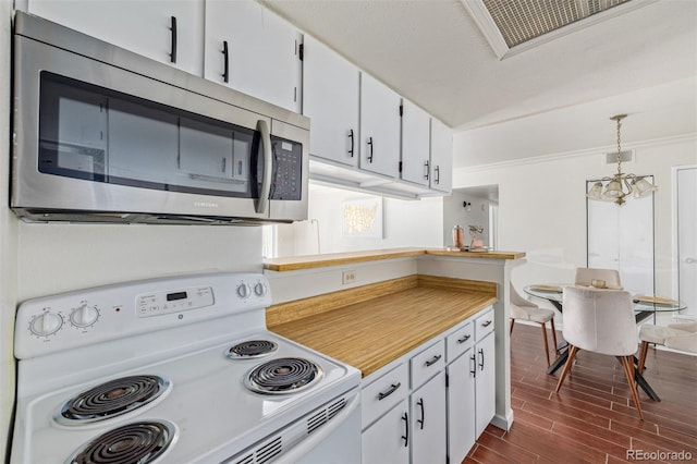 kitchen with electric range, decorative light fixtures, an inviting chandelier, white cabinets, and dark hardwood / wood-style floors