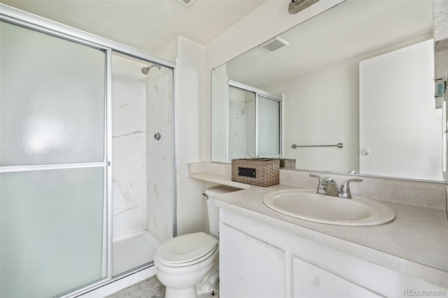 bathroom featuring vanity, toilet, and an enclosed shower