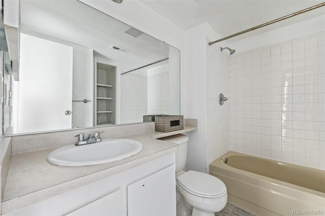 full bathroom with vanity, toilet, and tiled shower / bath