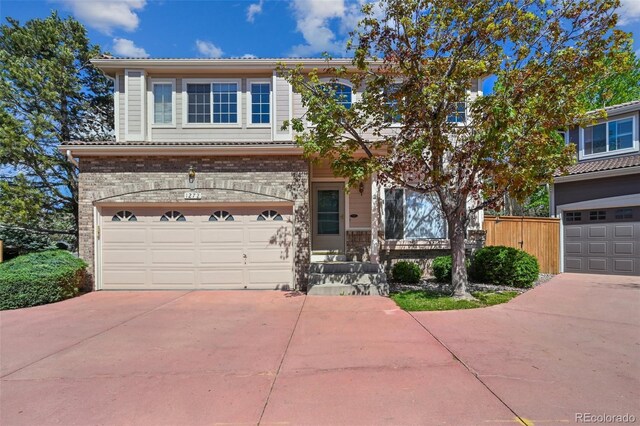 1272 Braewood Ave, Highlands Ranch, CO 80129 - traditional-style house featuring concrete driveway, an attached garage, fence, and brick siding
