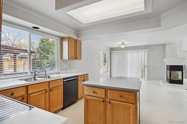 1272 Braewood Ave, Highlands Ranch, CO 80129 - kitchen with black dishwasher, a sink, light flooring, and a tray ceiling