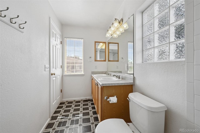 1272 Braewood Ave, Highlands Ranch, CO 80129 - bathroom with healthy amount of natural light, tile patterned floors, toilet, vanity, and a textured wall