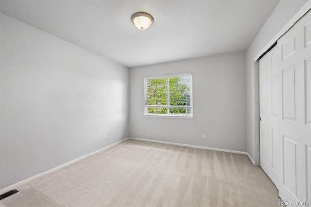 1272 Braewood Ave, Highlands Ranch, CO 80129 - unfurnished bedroom featuring a closet, carpet flooring, and baseboards