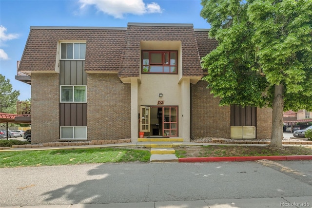 7755 E Quincy Ave Unit 107D2, Denver, CO 80237 - view of property featuring uncovered parking