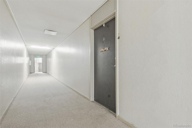 7755 E Quincy Ave Unit 107D2, Denver, CO 80237 - corridor with light colored carpet and baseboards