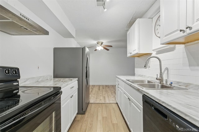 7755 E Quincy Ave Unit 107D2, Denver, CO 80237 - kitchen featuring black appliances, ventilation hood, a sink, light wood-style flooring, and tasteful backsplash