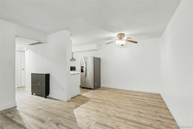 7755 E Quincy Ave Unit 107D2, Denver, CO 80237 - unfurnished room with ceiling fan, light wood-style flooring, baseboards, and a textured ceiling