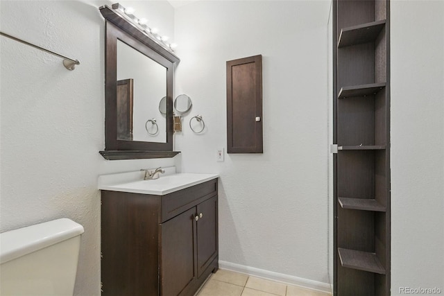 7755 E Quincy Ave Unit 107D2, Denver, CO 80237 - bathroom with vanity, toilet, tile patterned flooring, and baseboards