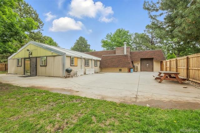 7755 E Quincy Ave Unit 107D2, Denver, CO 80237 - back of property with a patio and a chimney