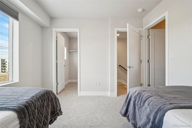 carpeted bedroom with a spacious closet