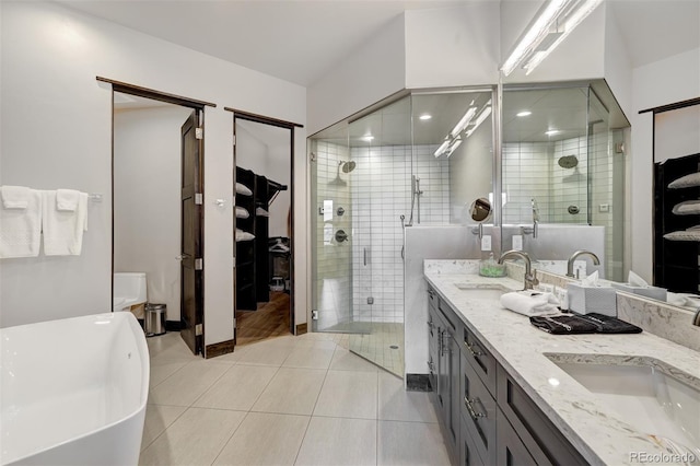 bathroom with independent shower and bath, vanity, and tile patterned floors