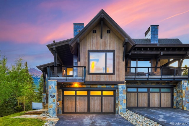 view of front of home with a garage and a balcony