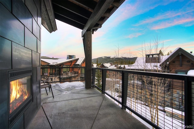 balcony at dusk with a large fireplace