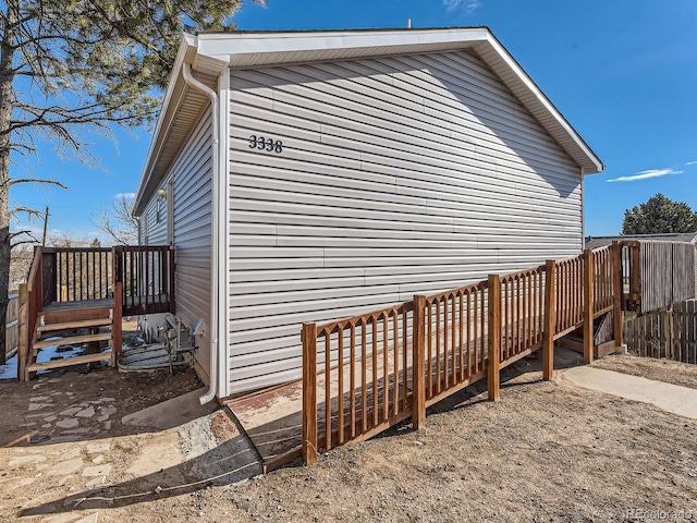 view of side of property featuring a wooden deck