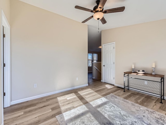 unfurnished bedroom featuring ceiling fan, light hardwood / wood-style floors, and lofted ceiling