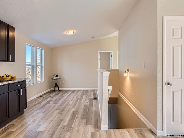 clothes washing area featuring light hardwood / wood-style flooring