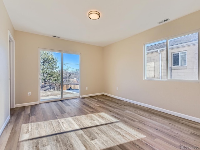 spare room featuring light hardwood / wood-style floors