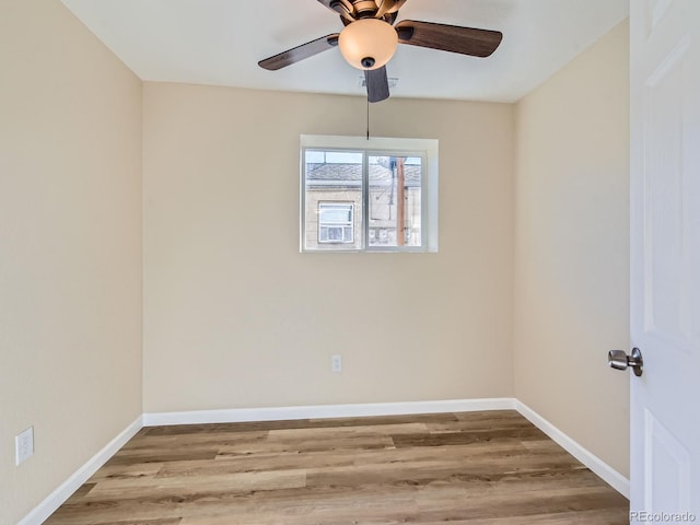 spare room with light hardwood / wood-style floors and ceiling fan