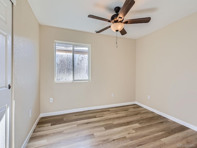 spare room with ceiling fan and light wood-type flooring