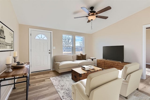 living room featuring ceiling fan and light hardwood / wood-style flooring