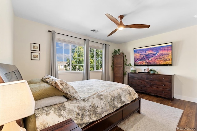 bedroom with ceiling fan and dark hardwood / wood-style flooring