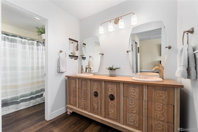 bathroom with vanity, toilet, and wood-type flooring